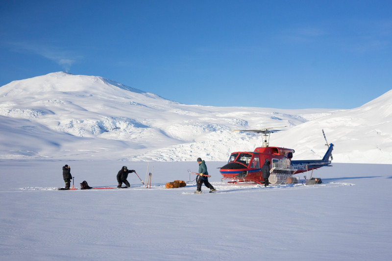 Stodt, Wannamaker and Hill set up equipment on snowy Mt Erebus