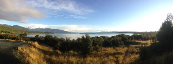 panormaic photo of a lake with hills on the far shore